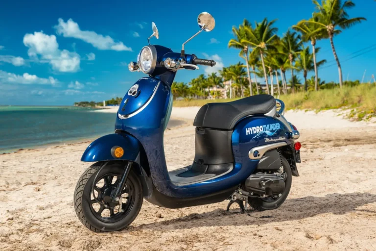 Blue Honda scooter rental parked on a Key West beach